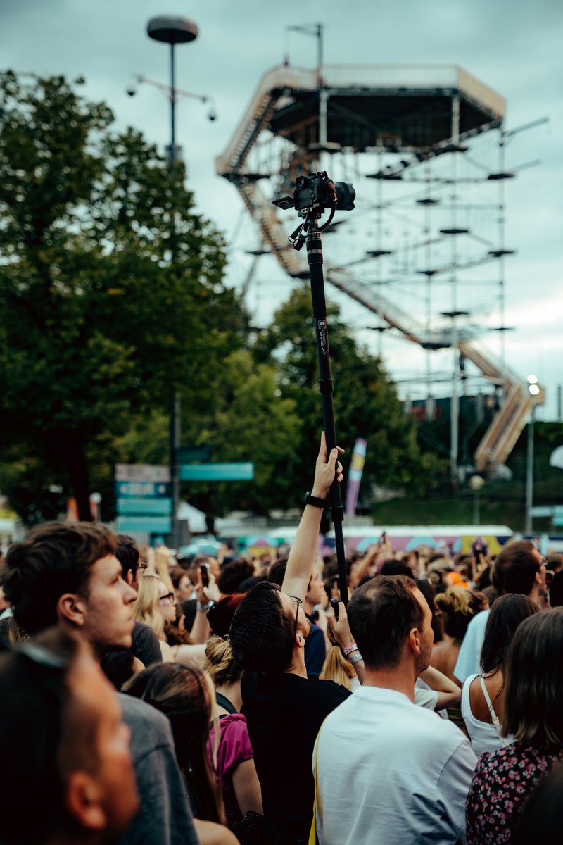 Luke capturing the festival from the crowd with a raised camera at SUPERBLOOM 2026.